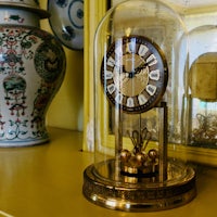 a clock under a glass dome